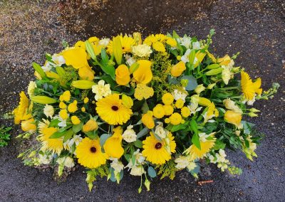 yellow casket spray